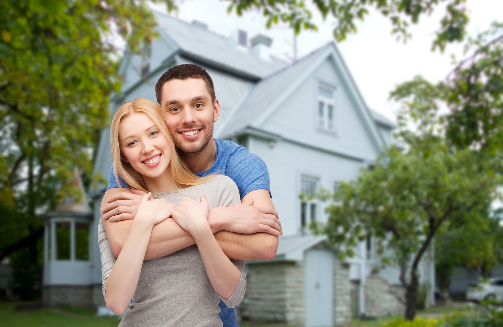 Couple Hugging over House 