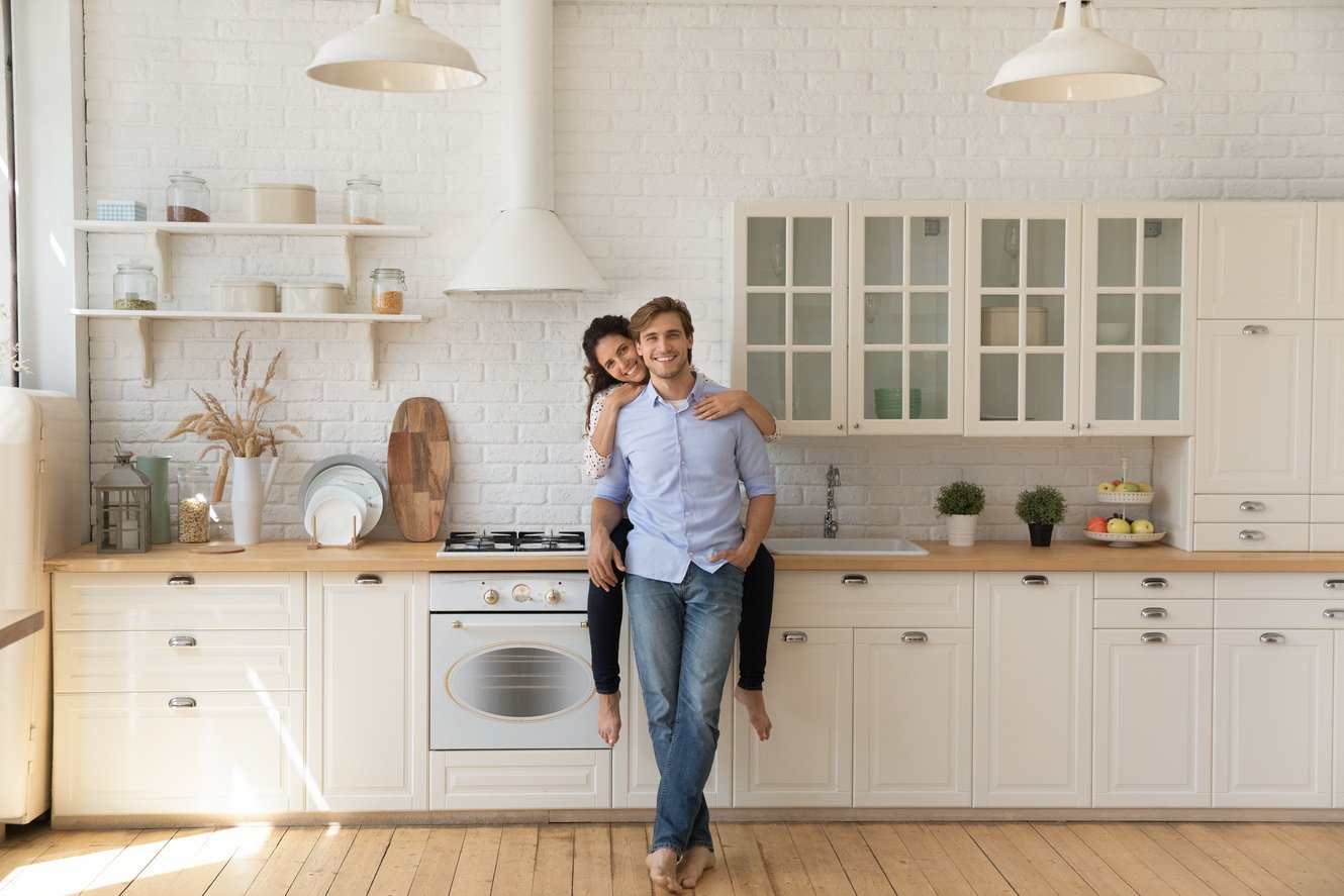 Loving young couple homeowners glad of buying new kitchen furniture